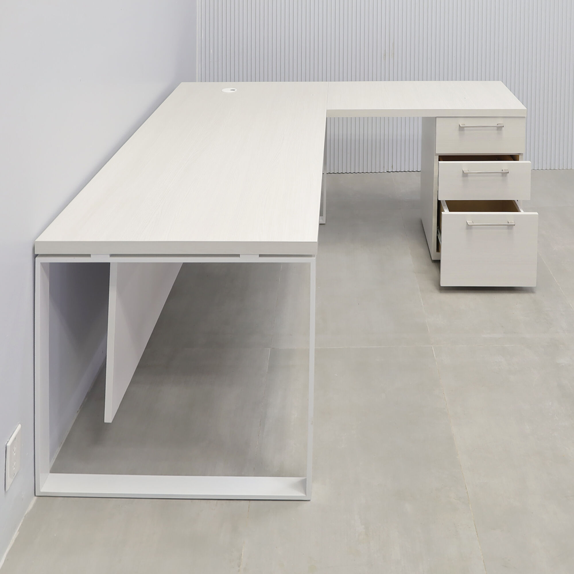 70x65-inch Aspen L-Shape Executive Desk in white ash laminate top, white powder coated metal legs, dover off-white laminate privacy panel, white ash laminate credenza.