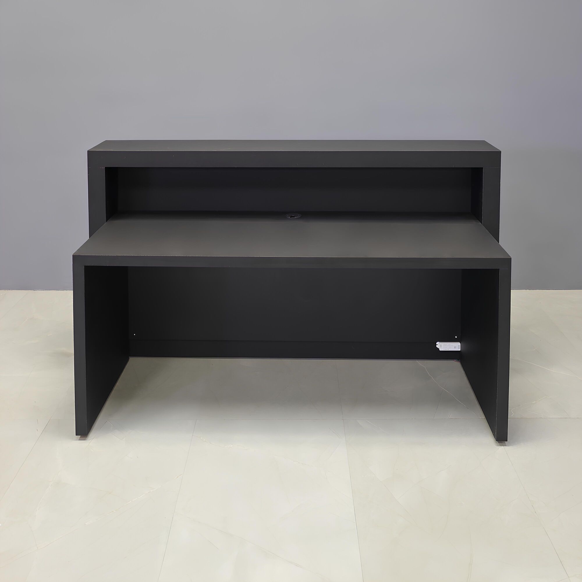 72-inch Vegas Designer Reception Desk in black traceless laminate main desk, spanish limestone engineered surface slats front panel, and warm white LED.