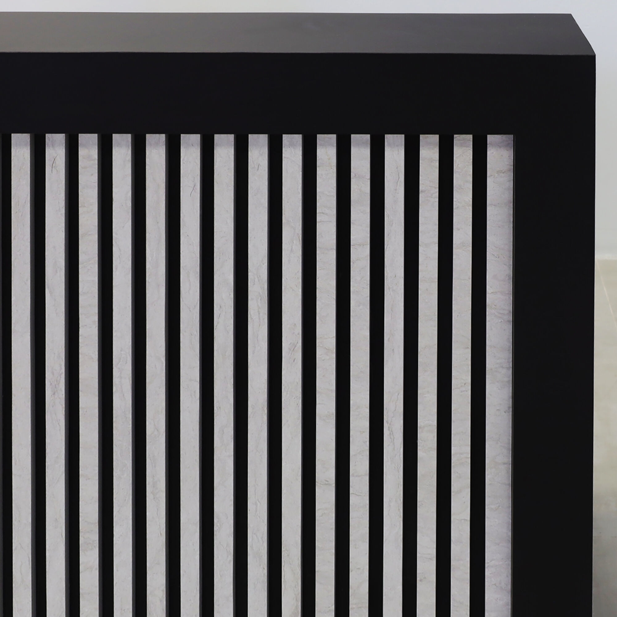 72-inch Vegas Designer Reception Desk in black traceless laminate main desk, spanish limestone engineered surface slats front panel, and warm white LED.
