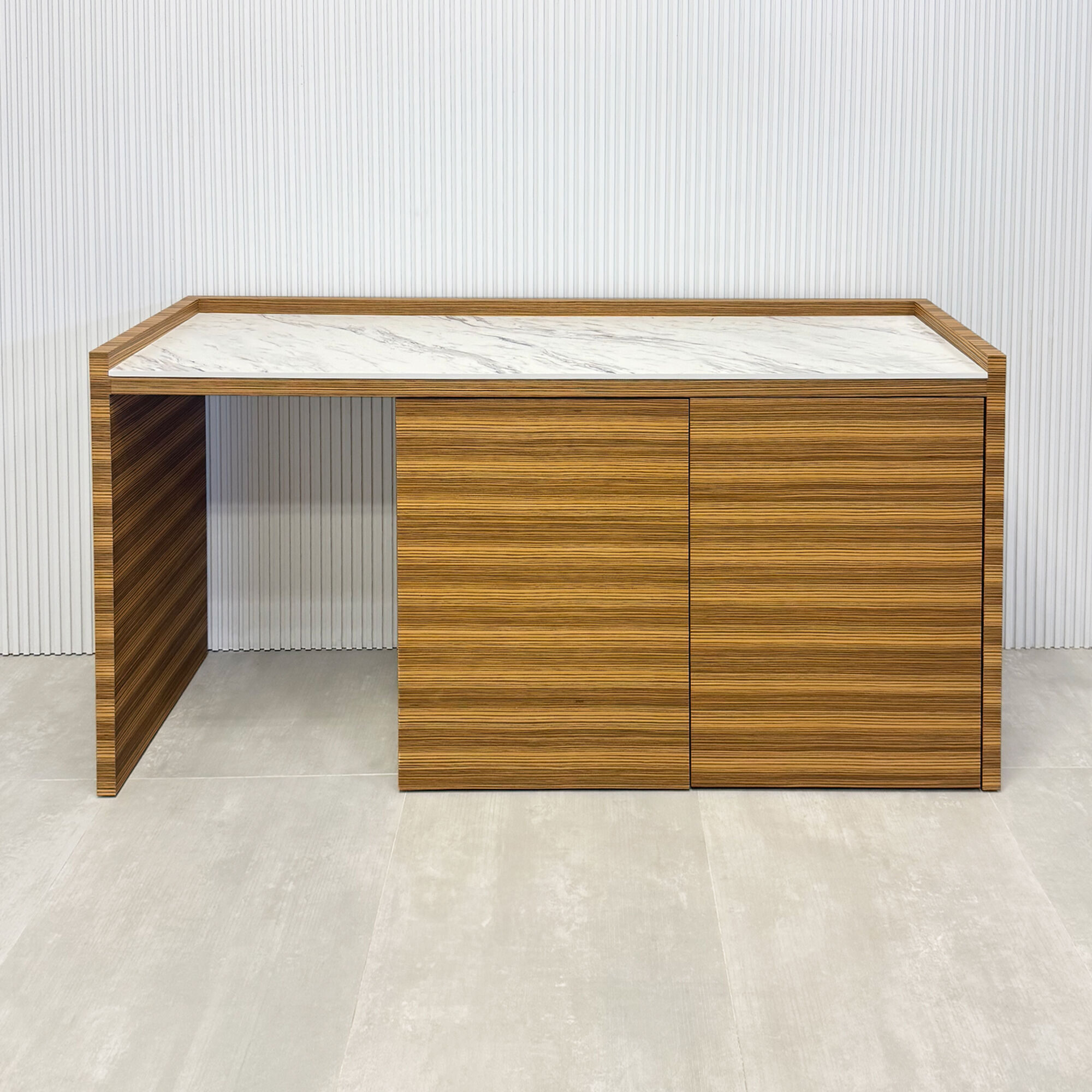 72-inch Avenue Beverage Station with calcutta blanc engineered surface top, zebrawood veneer main body, and push-to-open door mechanism.