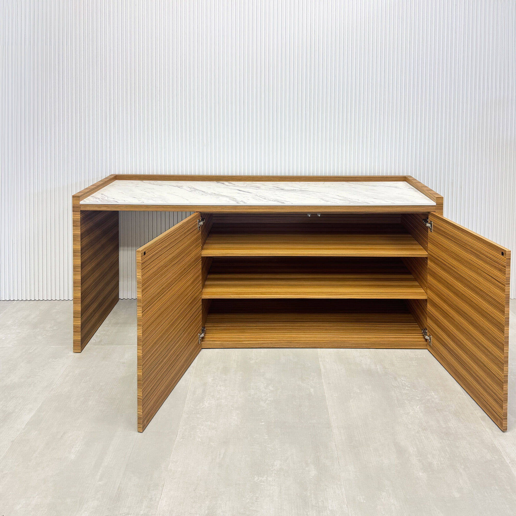 72-inch Avenue Beverage Station with calcutta blanc engineered surface top, zebrawood veneer main body, and push-to-open door mechanism.