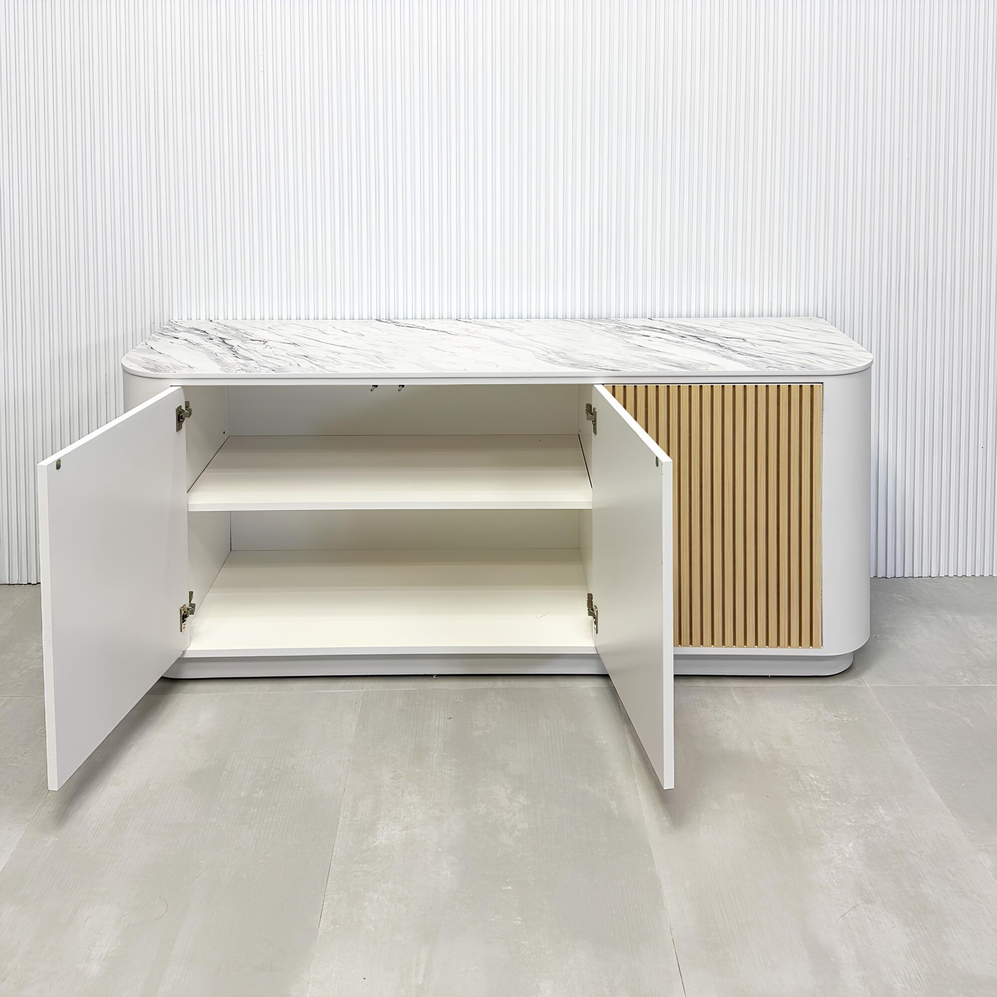 72-inch Florence Storage Credenza with 1/2 Calcutta engineered surface top, dover off white laminate credenza inside, and maple tambour front doors.