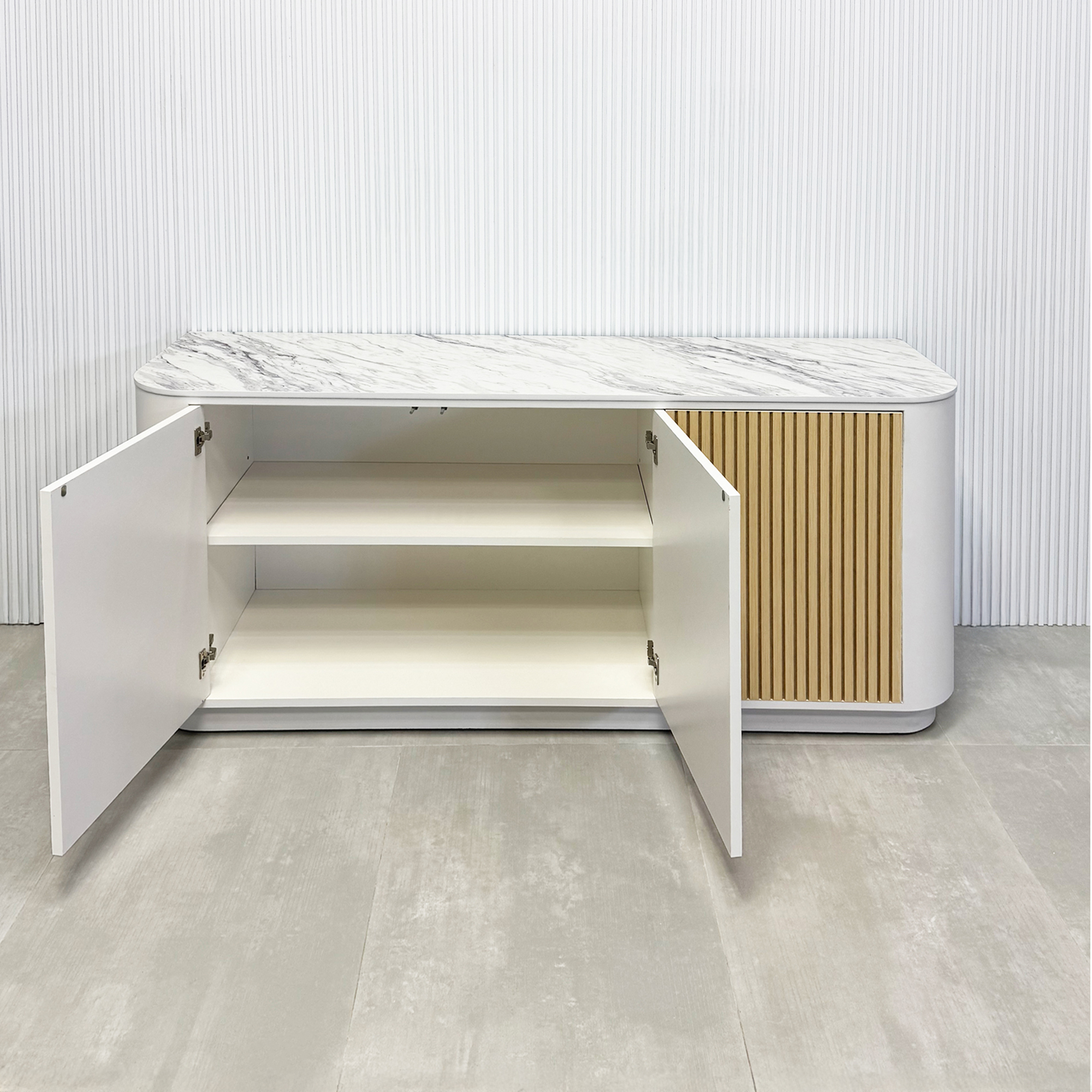 72-inch Florence Storage Credenza with 1/2 Calcutta engineered surface top, dover off white laminate credenza inside, and maple tambour front doors.