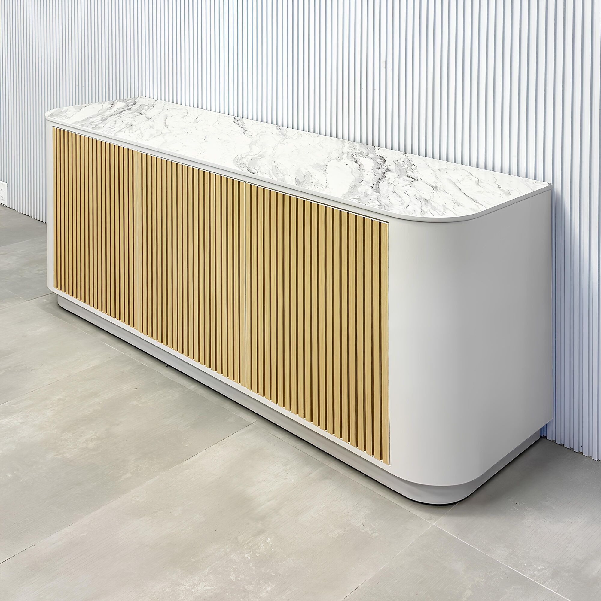 72-inch Florence Storage Credenza with 1/2 Calcutta engineered surface top, dover off white laminate credenza inside, and maple tambour front doors.