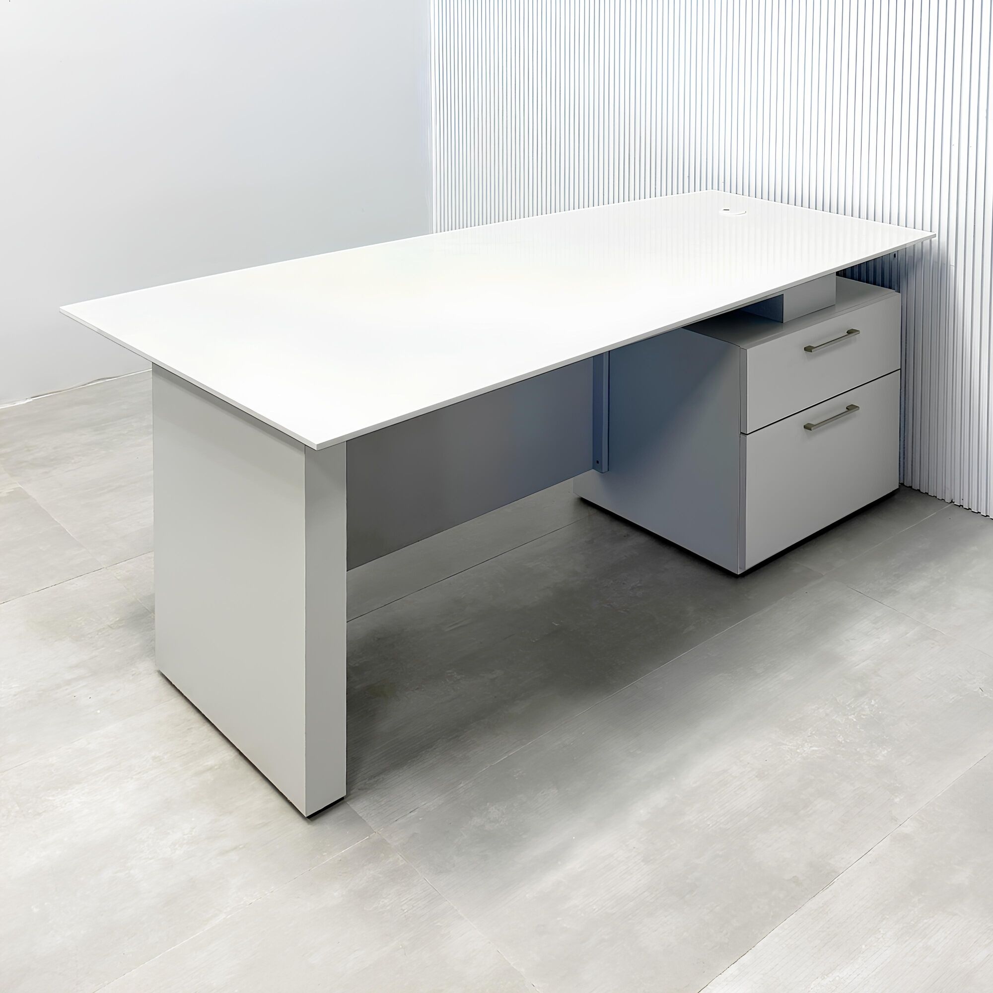 72-inch Avenue Curved Executive Desk with white solid engineered surface top, folkstone gray base & cabinet, and folkstone gray privacy panel.