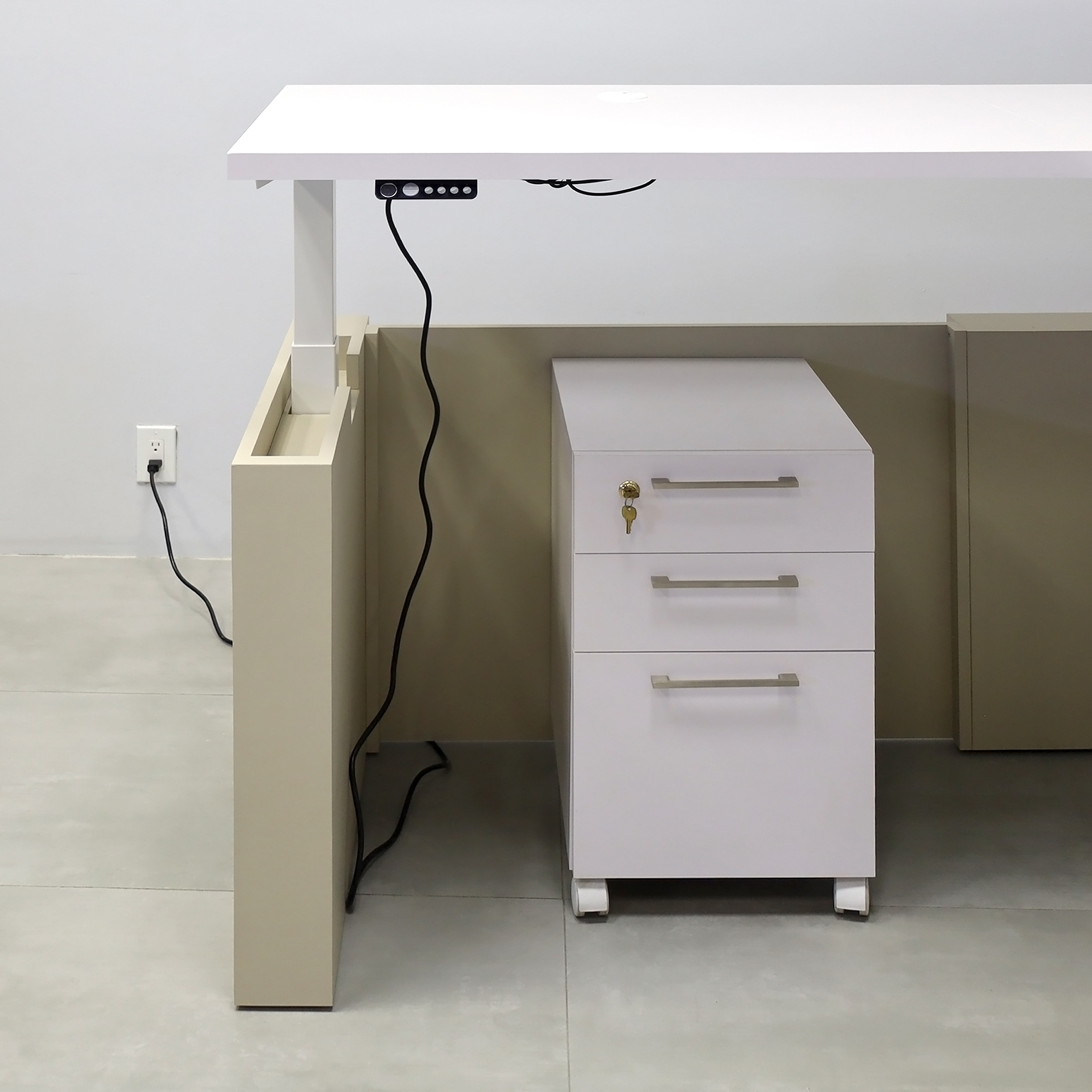 72x72-inch Denver L-Shape Laminate Executive Desk Sit-Stand Mechanism with White Gloss laminate top, Taupe matte PVC laminate base, and Sit-Stand Mechanism in White.