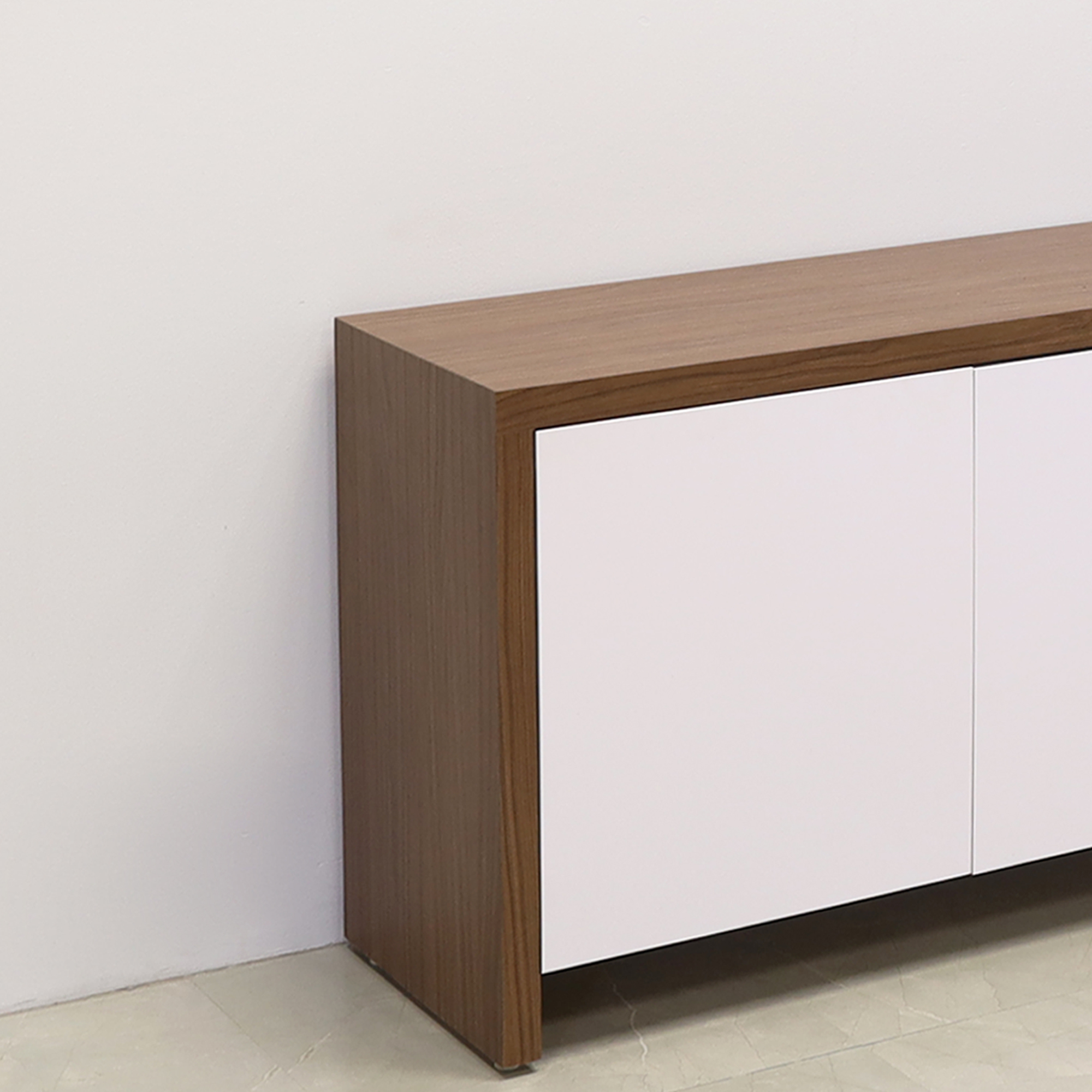 74 inches Boston Storage Credenza in walnut heights laminate credenza and white matte laminate doors with push mechanism shown here.