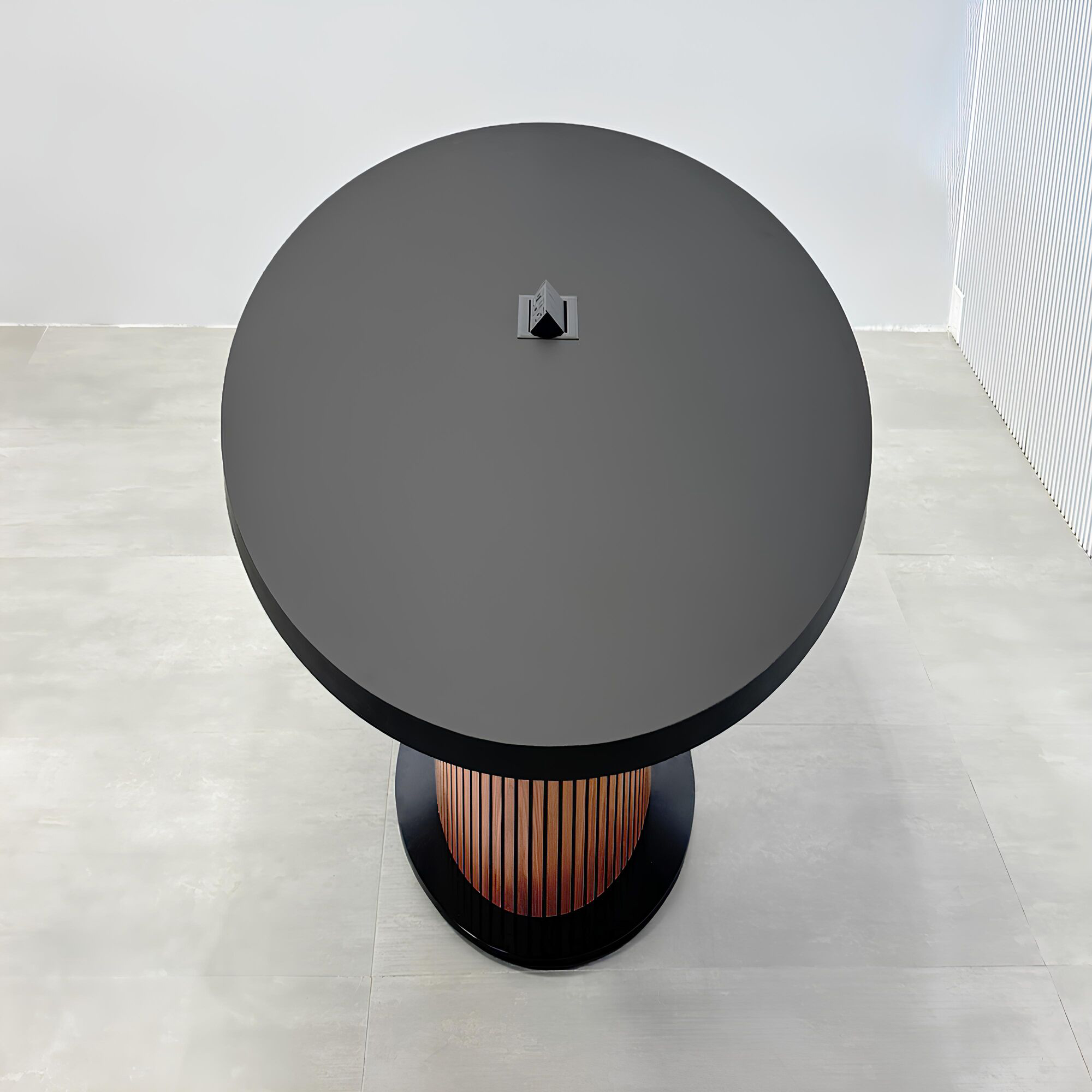 84-inch Newton Oval Conference Table with laminate top and X3 Base with black traceless laminate top, walnut tambour with black background pedestal, black metal powder coated base, and mx2 in black.
