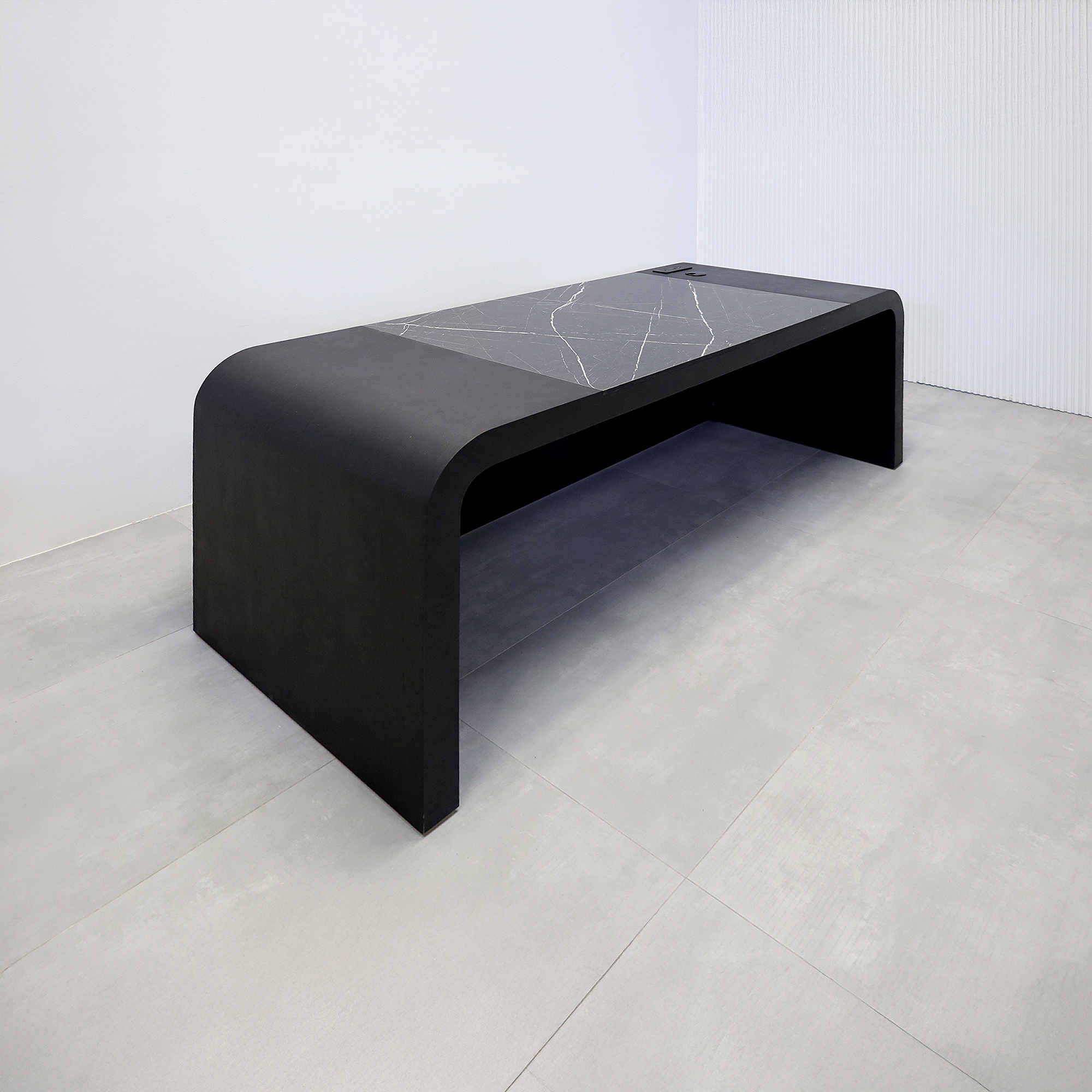 84-inch Milano Executive Desk with Pietra Noir engineered surface top, Black Cinder matte laminate desk, Ebony tambour, and power box in Black.