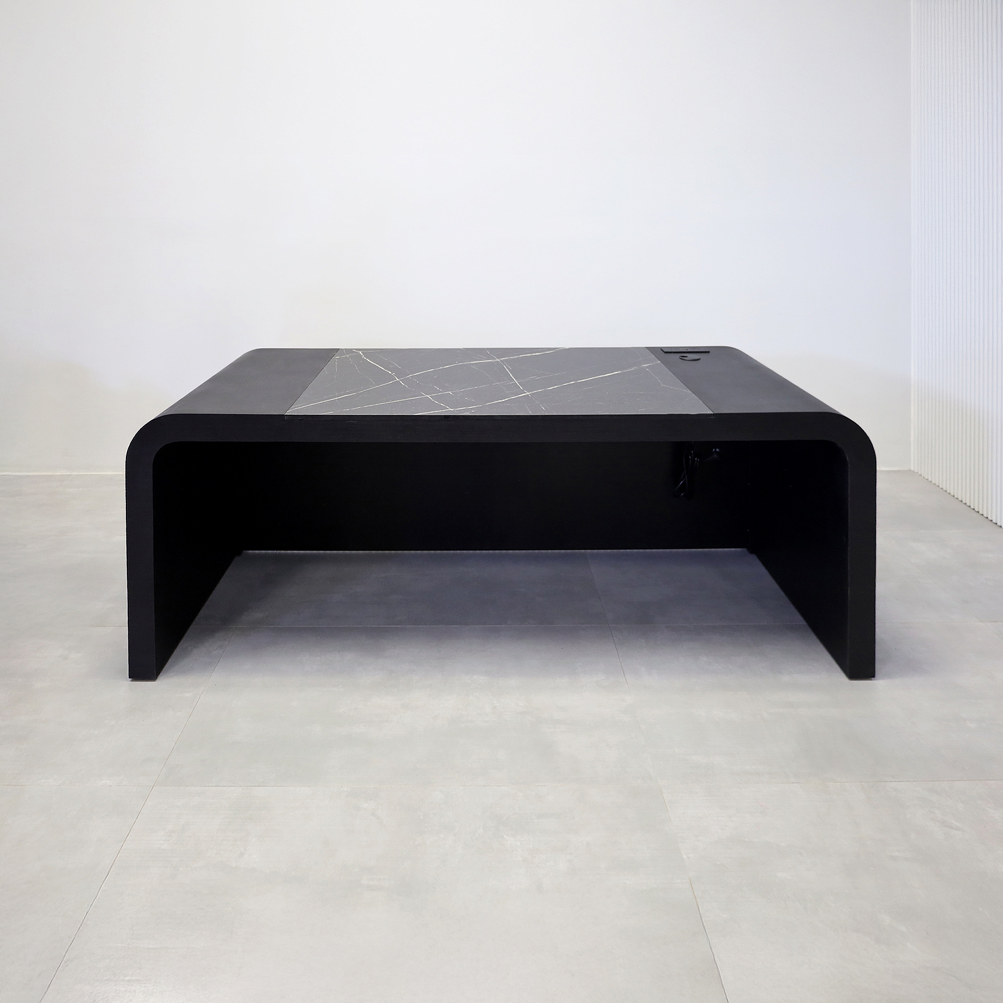 84-inch Milano Executive Desk with Pietra Noir engineered surface top, Black Cinder matte laminate desk, Ebony tambour, and power box in Black.