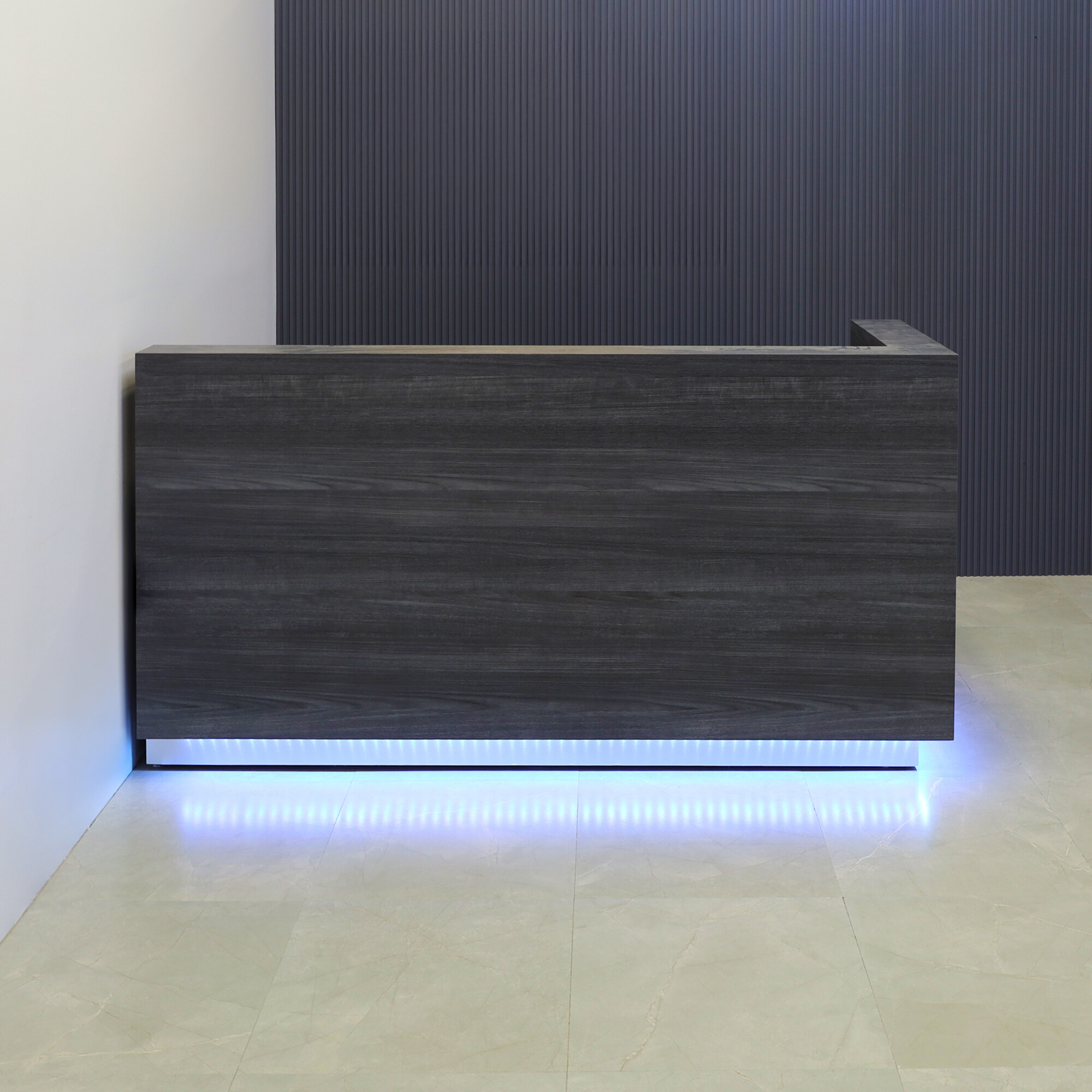 84-inch Dallas L-Shape Custom Reception Desk, right side l-panel when facing front in storm teakwood matte laminate main desk and brushed aluminum toe-kick, with multi-colored LED, shown here.