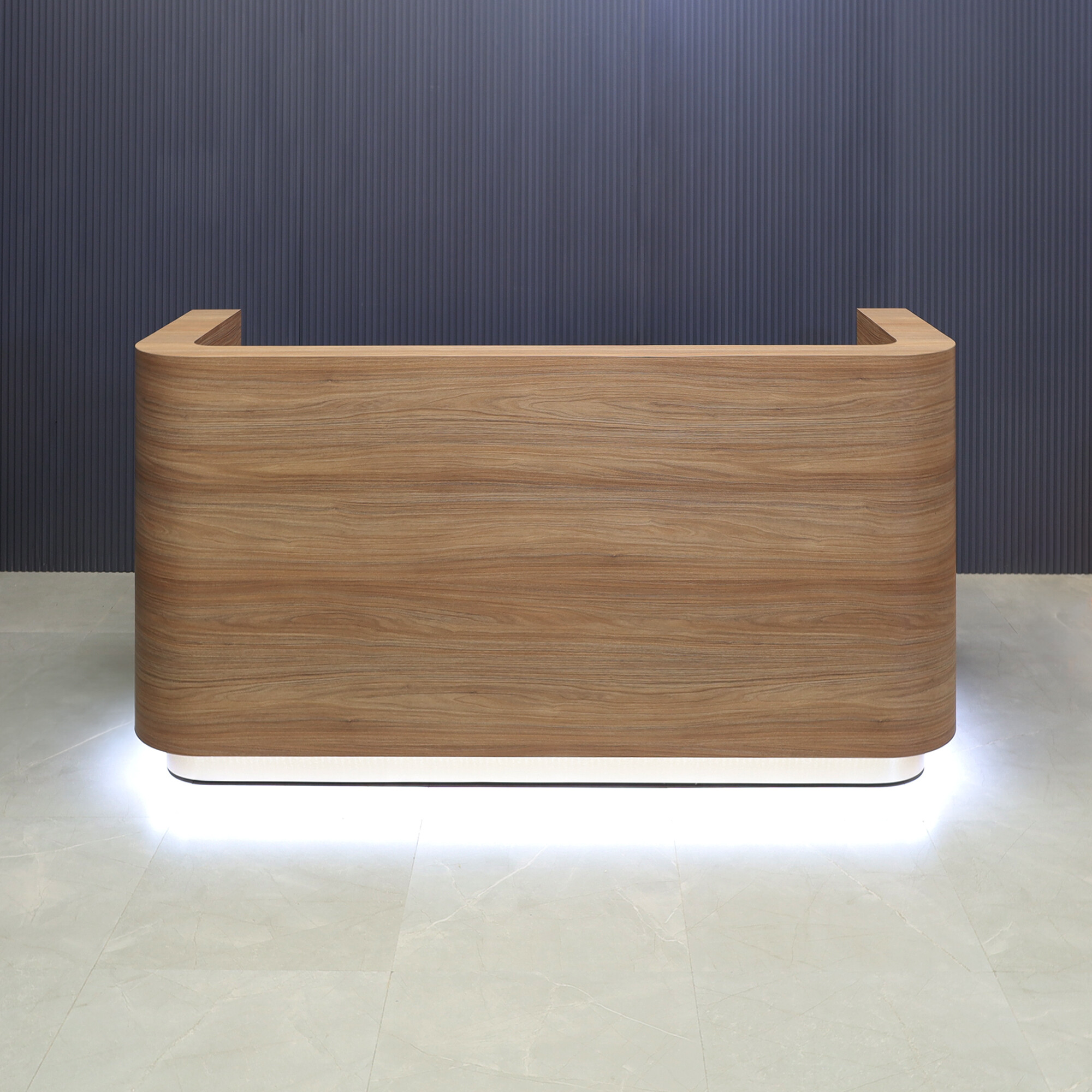 84-inch Nola Custom Reception Desk in uptown walnut matte laminate main desk and brushed gold toe-kick, with white LED, shown here.