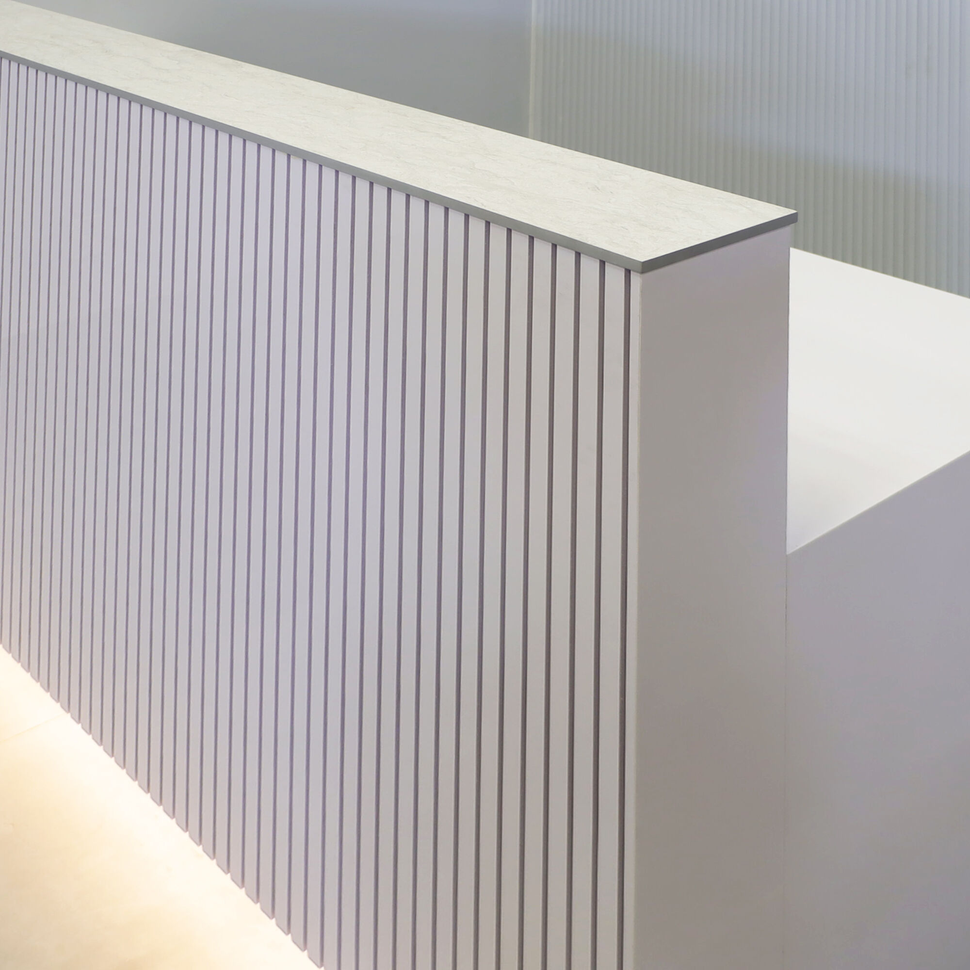84-inch Dallas Straight Reception Desk in white gloss tambour front, white gloss laminate workspace, and Toe-Kick, Warm White LED.