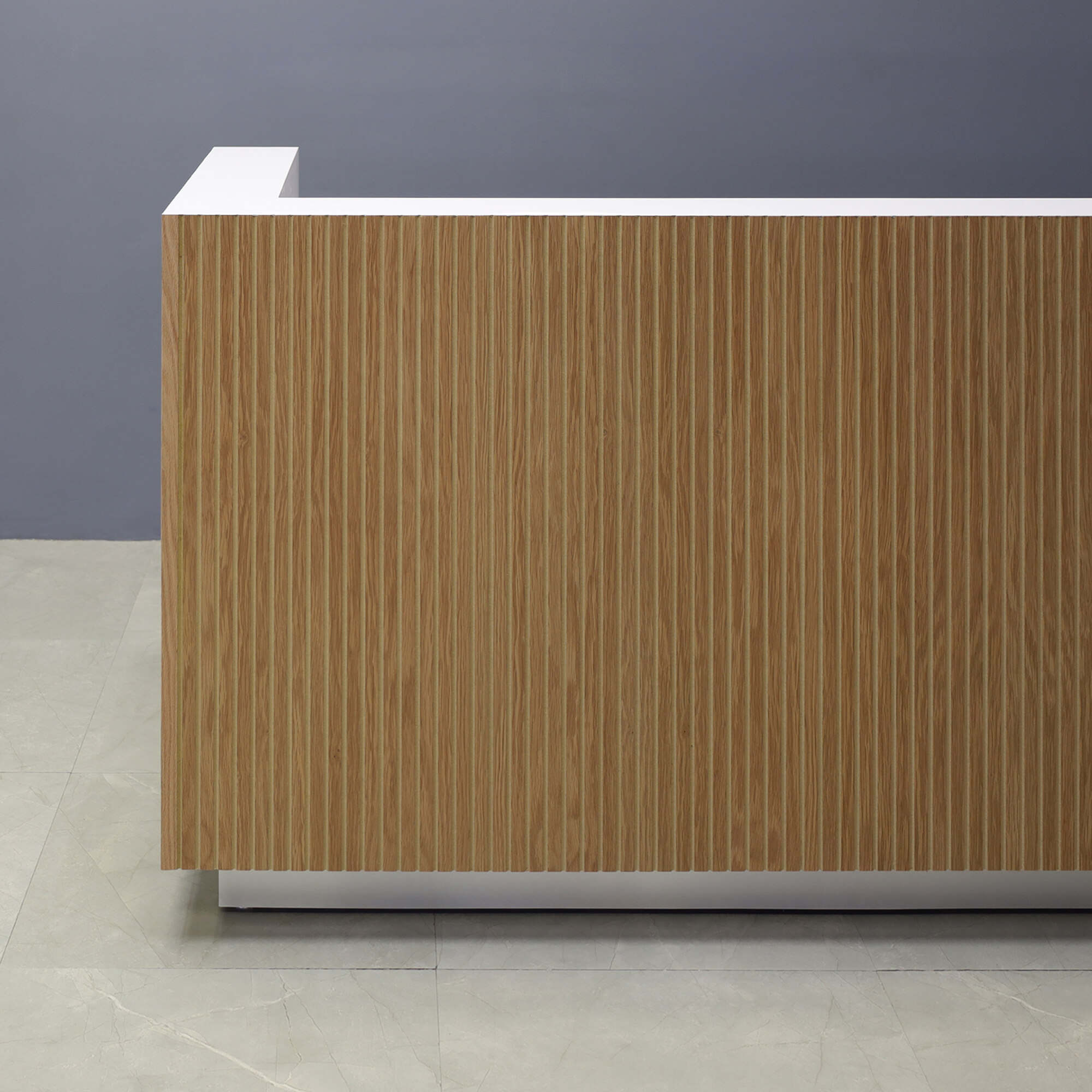 84-inch Dallas L-Shape Custom Reception Desk, left side l-panel when facing front in white oak tambour main desk, and white matte laminate workspace, with brushed aluminum toe-kick, shown here.