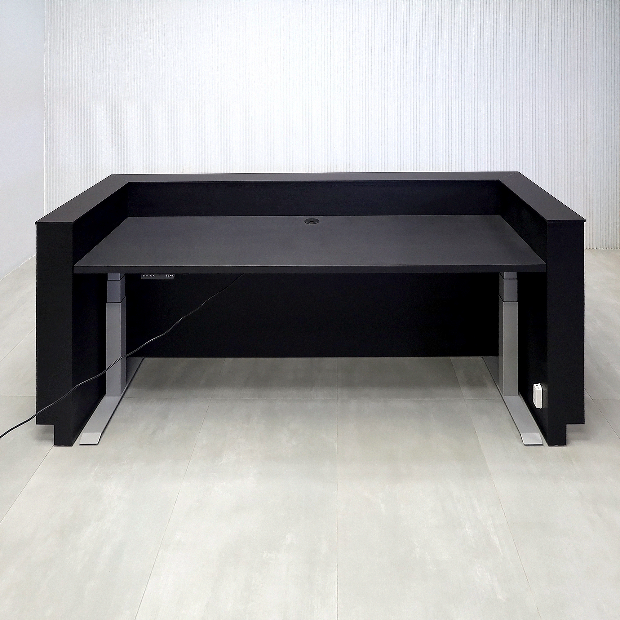 90-inch Pensacola Reception Desk with Black Cinder matte laminate desk and toe-kick. Spiced Chestnut laminate accent, Black traceless engineered surface top, and White LED.