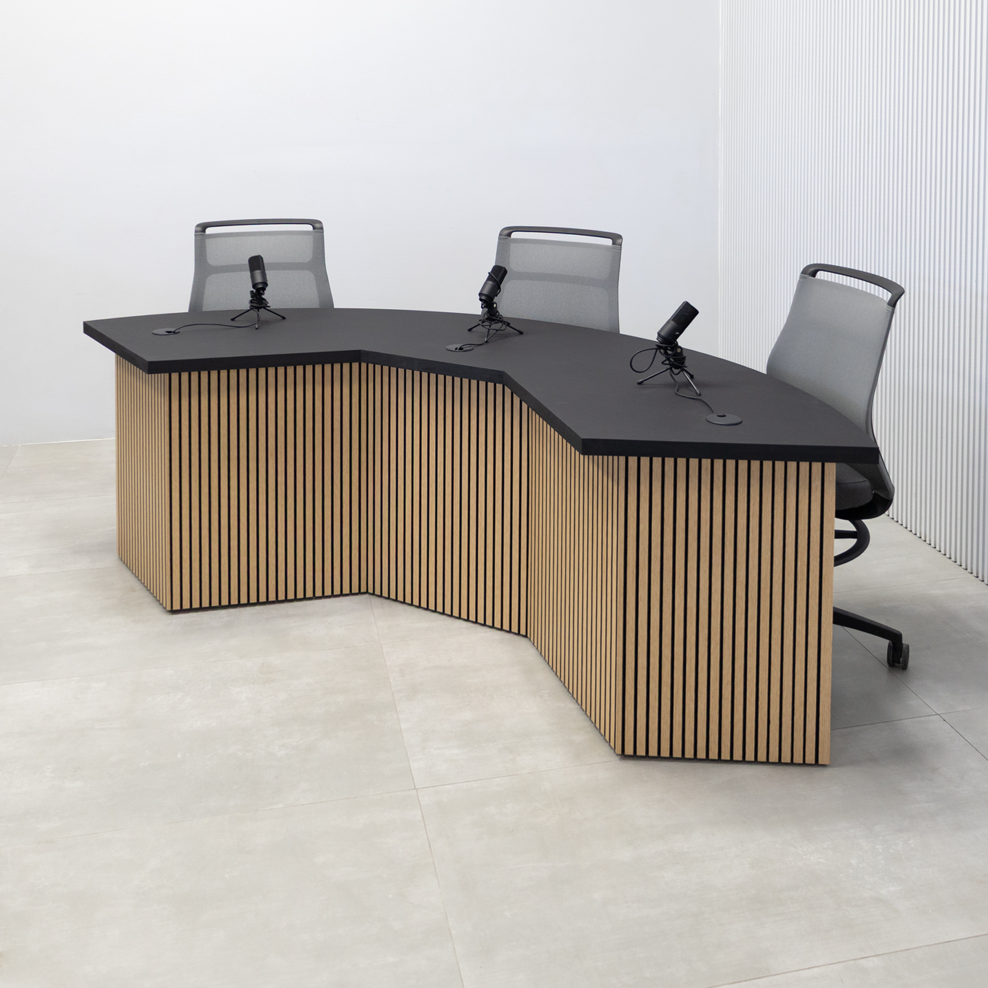 90-inch Tampa Bay Podcast Table with Black Cider matte laminate top, White Oak tambour & Black background front base, Black matte laminate back base. 