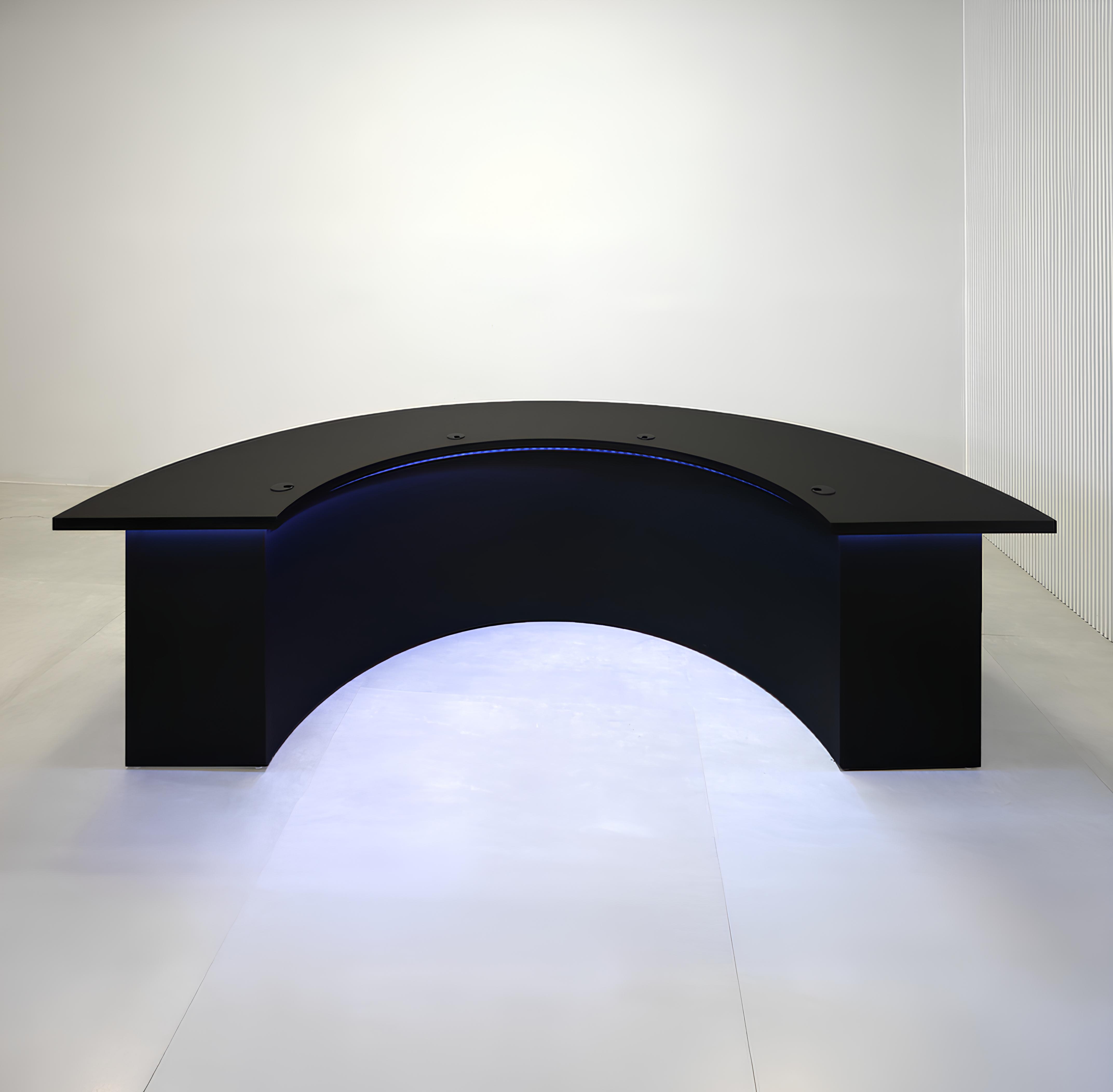 90-inch Half Moon Handmade Podcast Table with black traceless laminate top, black traceless laminate front of the base, black matte laminate back of the base, and Color LED.