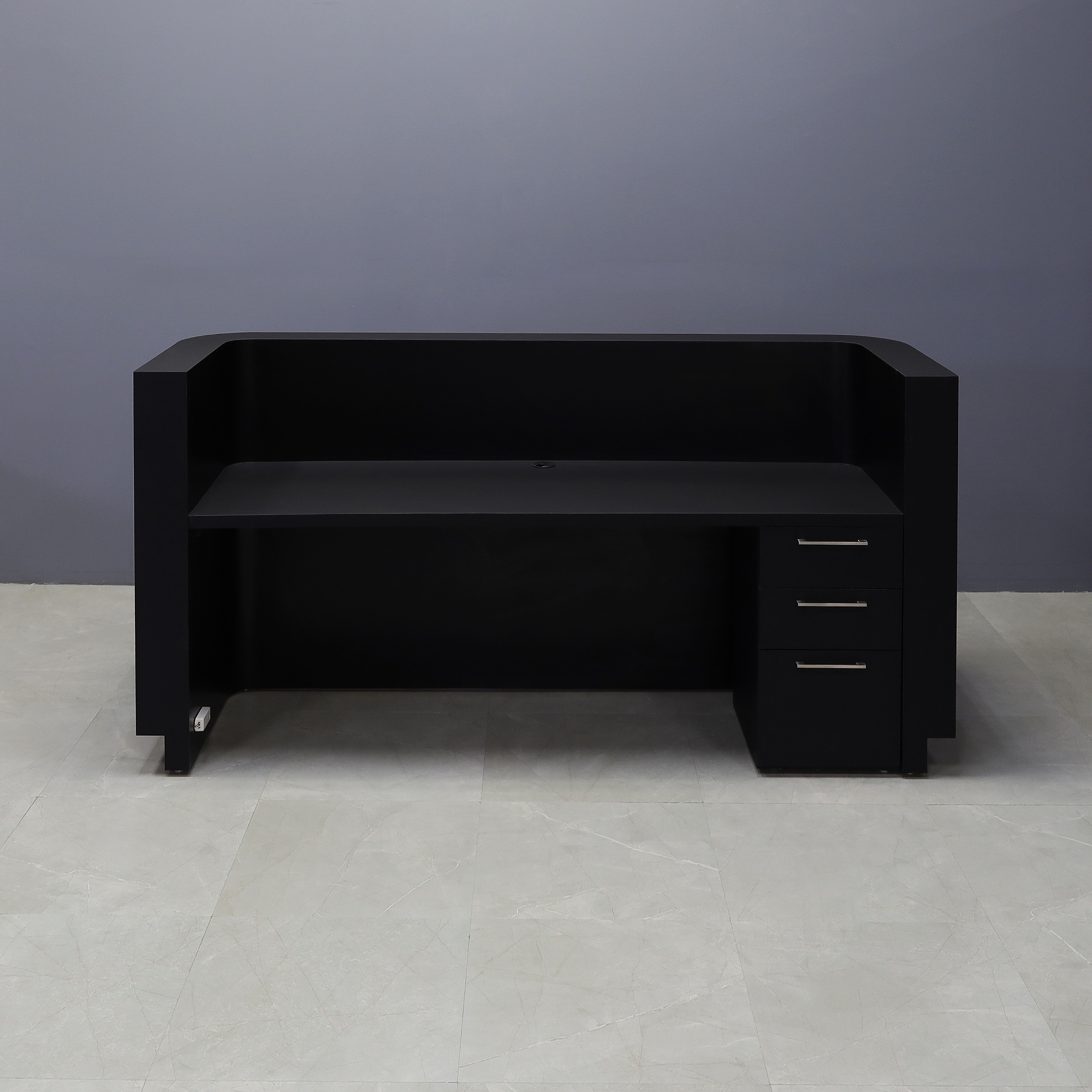 90-inch Nola Custom Reception Desk in black traceless laminate main desk and brushed aluminum toe-kick, with white LED,  and built-in storage on right side when sitting, shown here.