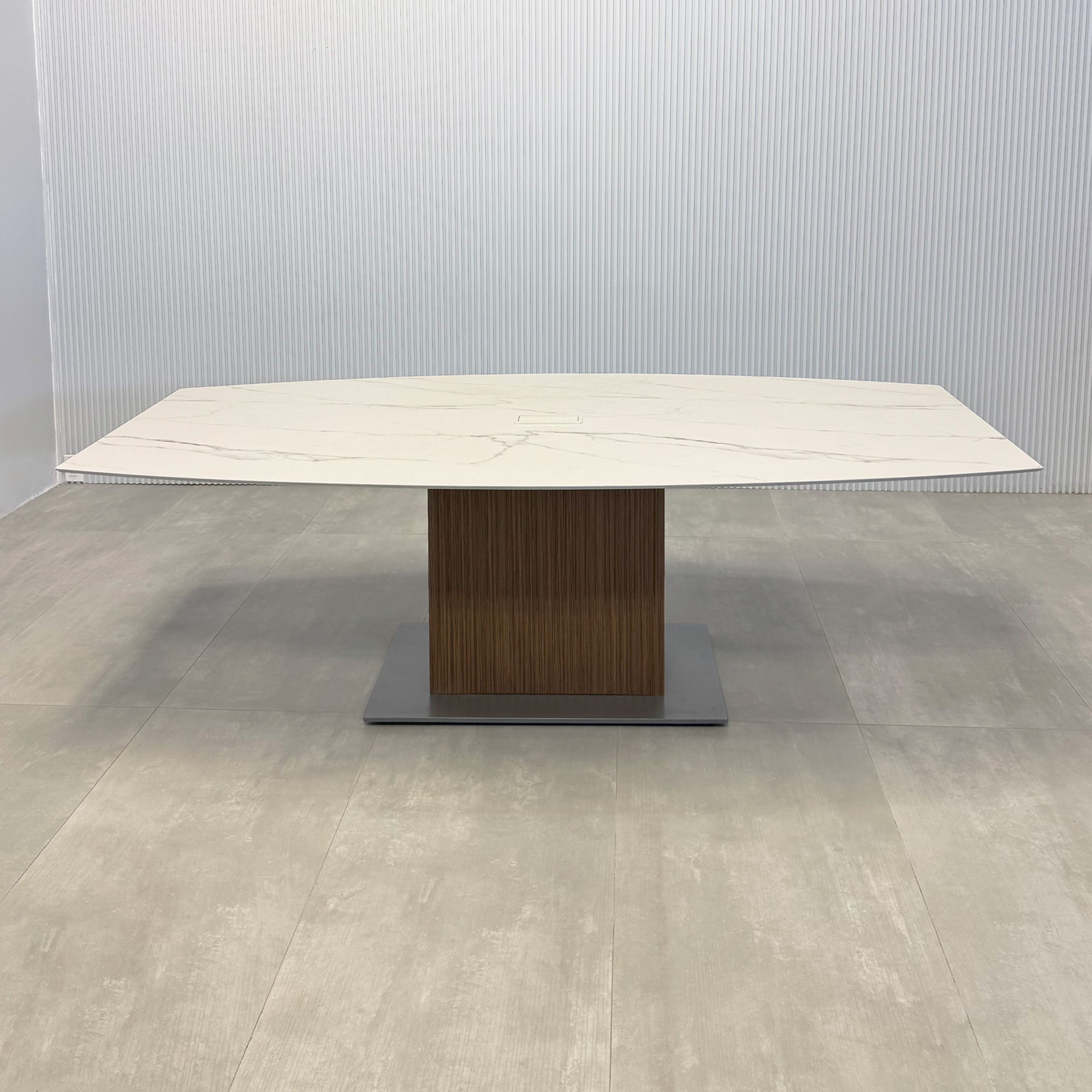 90-inch Aurora Boat Conference Table with Solenne Marble engineered surface top, Spiced Walnut tambour with Natural background pedestal, and Silver powder-coated base.