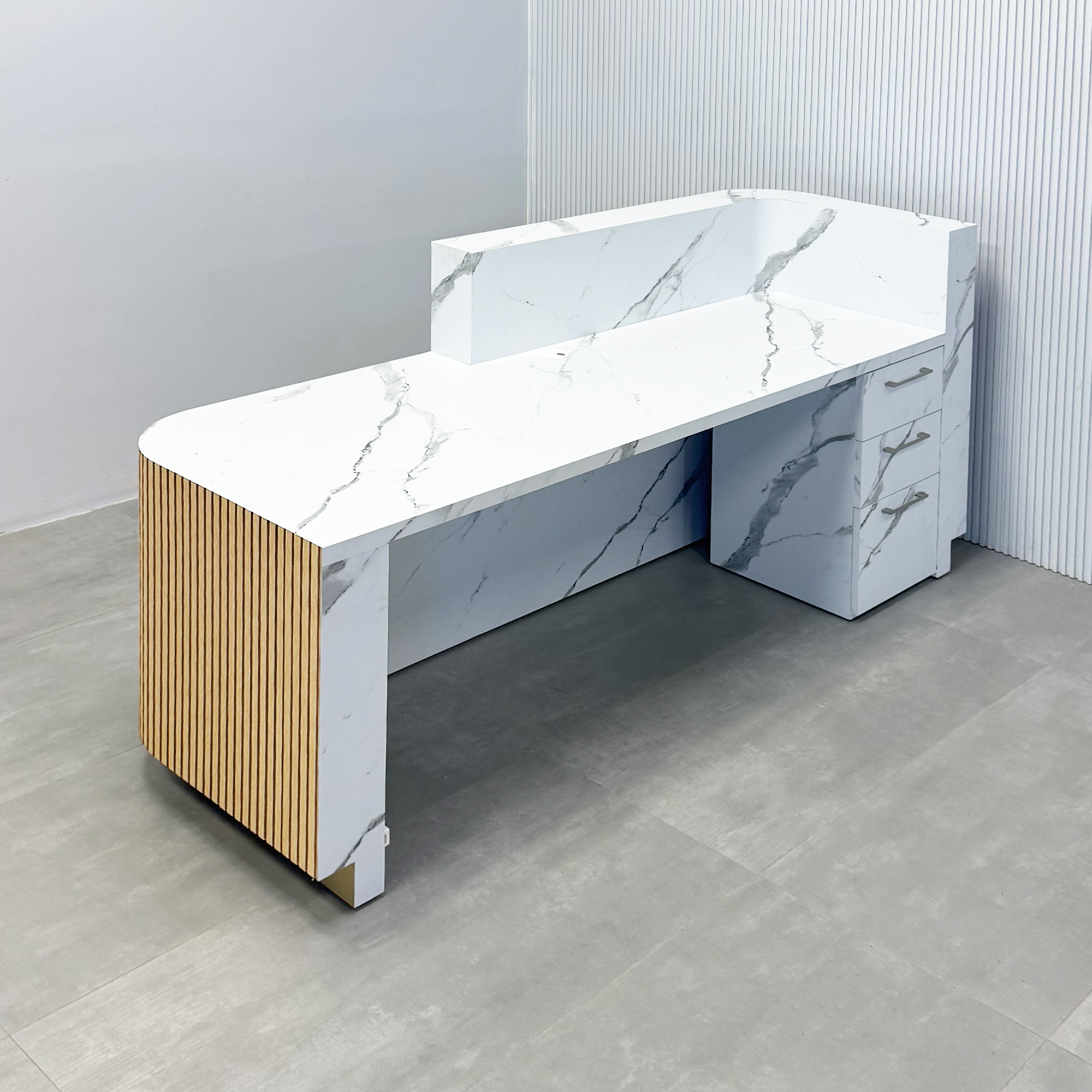 90-inch Nola Low Counter Reception Desk with white oak tambour desk, calcutta stone PVC laminate workspace & storage, gold aluminum toe-kick, and white LED.