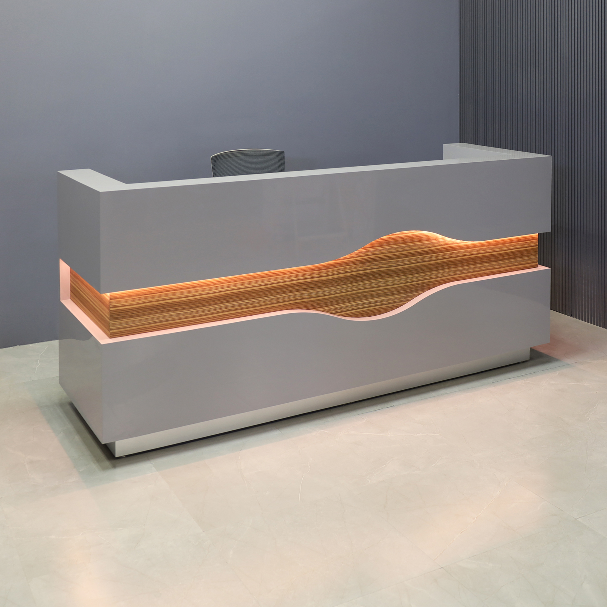 96-inch Wave Reception Desk in light gray gloss laminate desk and counter, zebrawood veneer wave accent front and brushed aluminum toe-kick, with warm white LED shown here.
