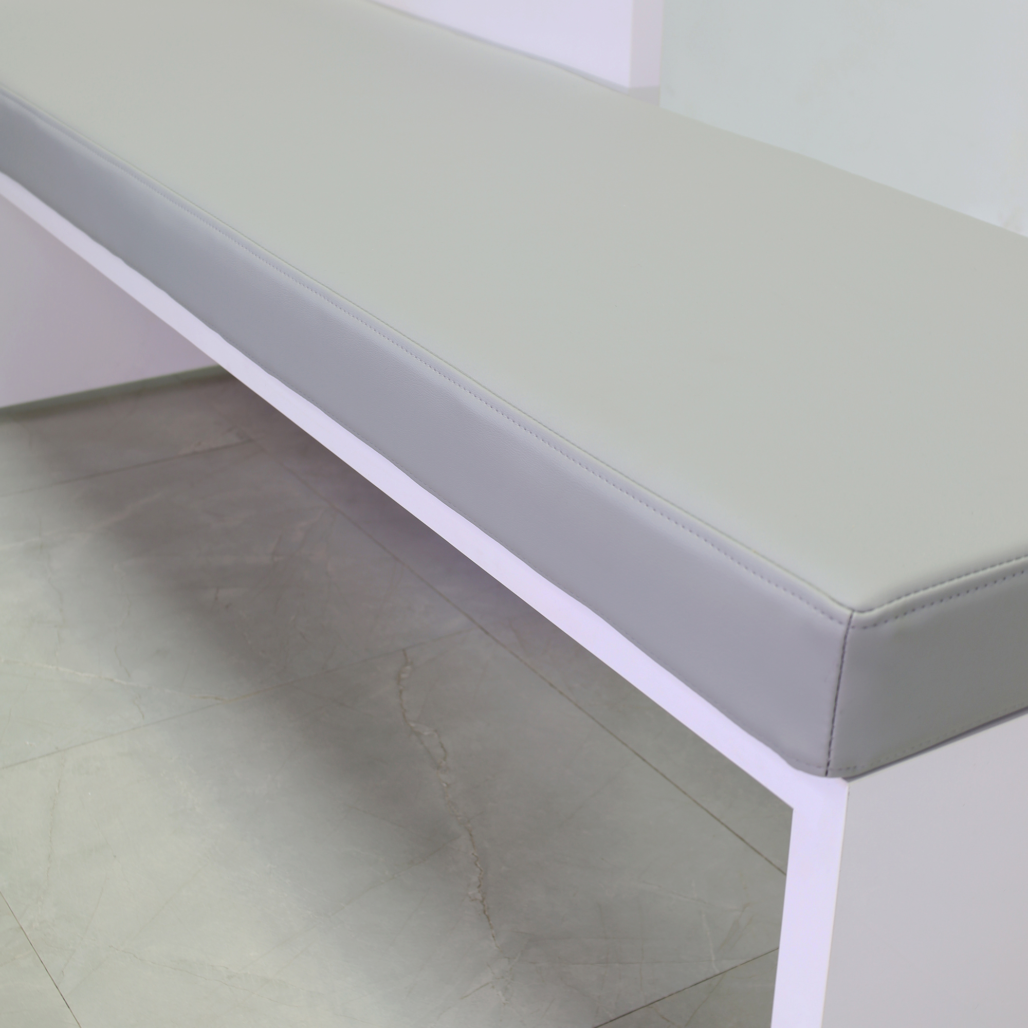 Astoria Sofa Bench with Cushion in gray leatherette and white gloss laminate finish sofa frame shown here.