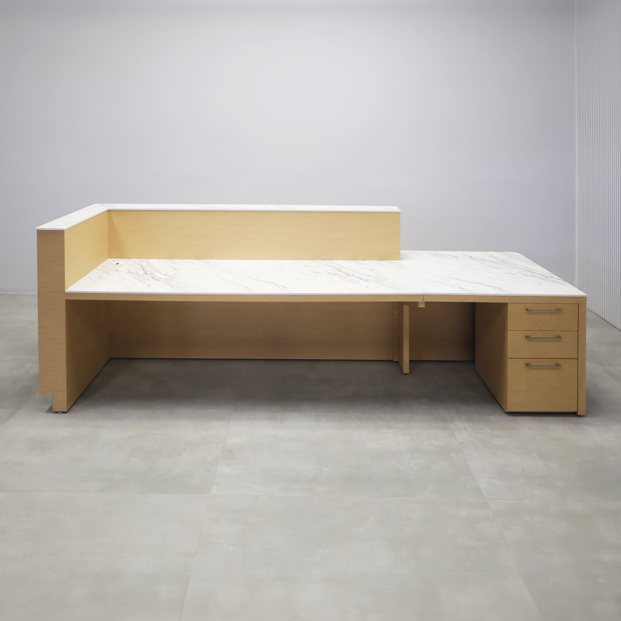 Dallas ADA Compliant Counter Custom Reception Desk with Calcutta Stone PVC workspace, White Oak Veneer body finish, and Brushed Aluminum toe-kick.