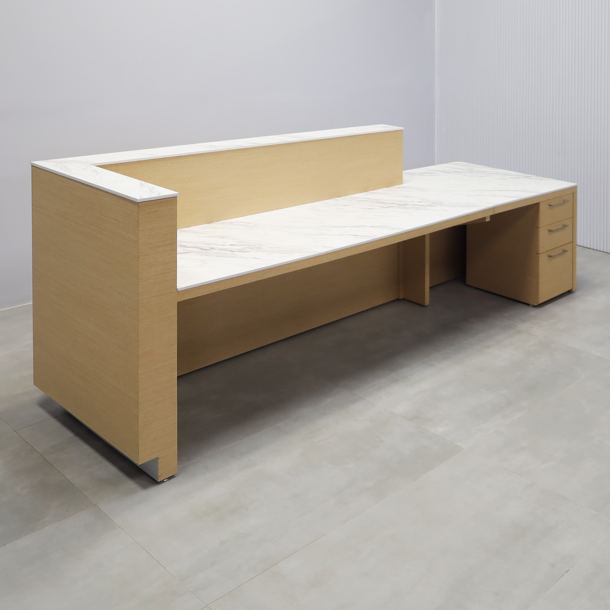 Dallas ADA Compliant Counter Custom Reception Desk with Calcutta Stone PVC workspace, White Oak Veneer body finish, and Brushed Aluminum toe-kick.