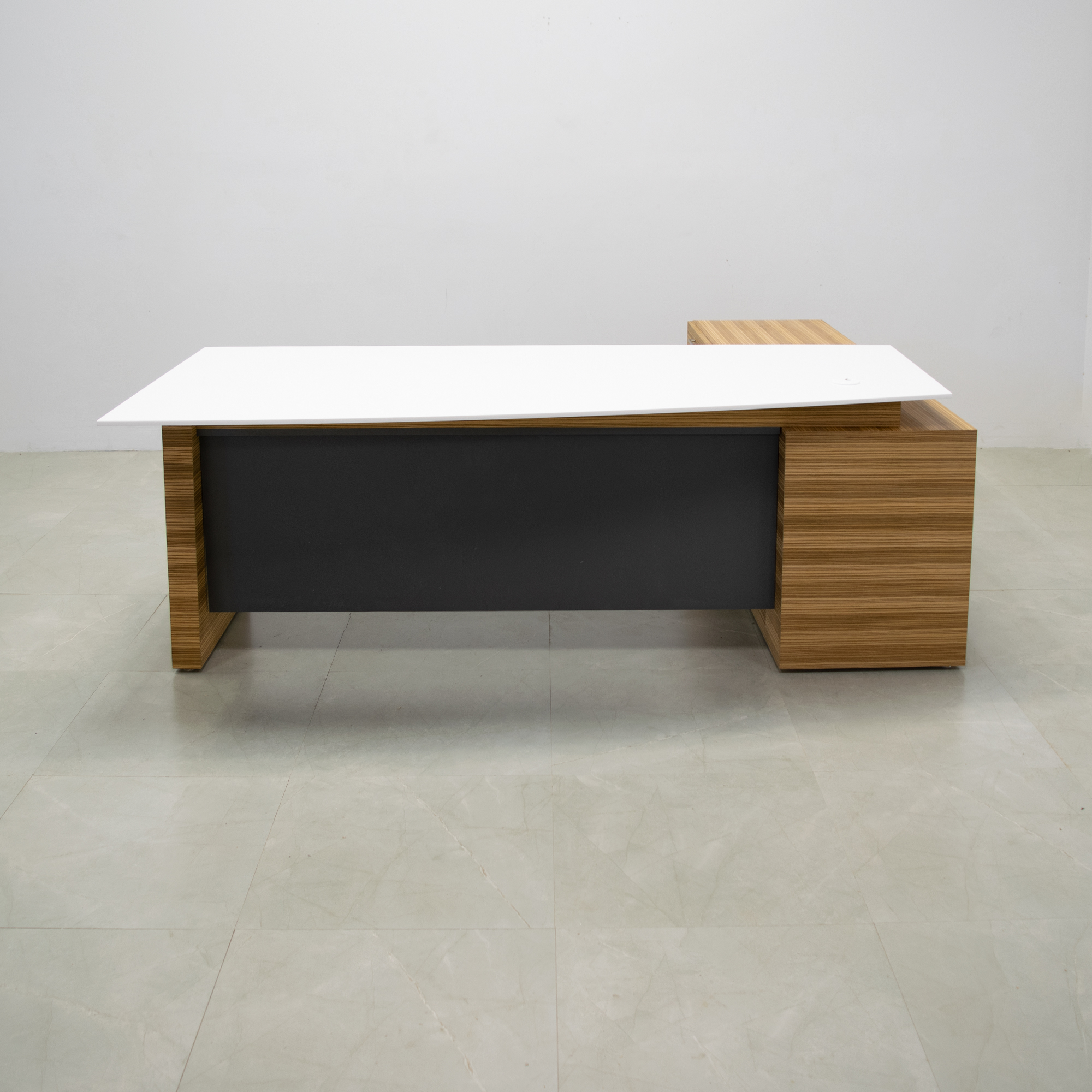 Avenue Curved Executive Desk With Credenza and Engineered Stone Top in white solid top and zebrawood veneer base & credenza, and dark gray traceless laminate privacy panel shown here. 