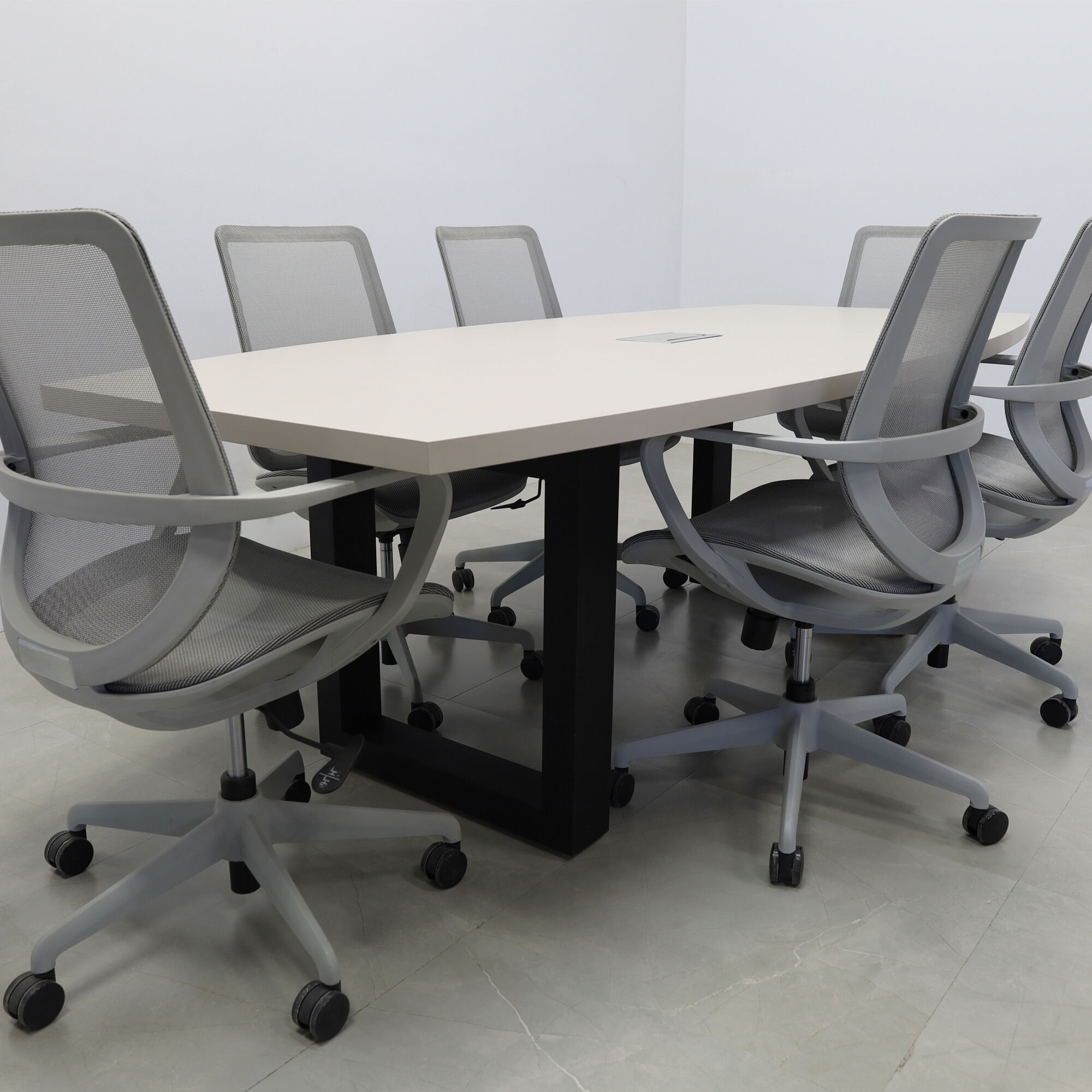 92-inch Newton Boat Shaped Conference Table in beige traceless laminate top, black metal u-legs powder coated, and silver MX3 power box.