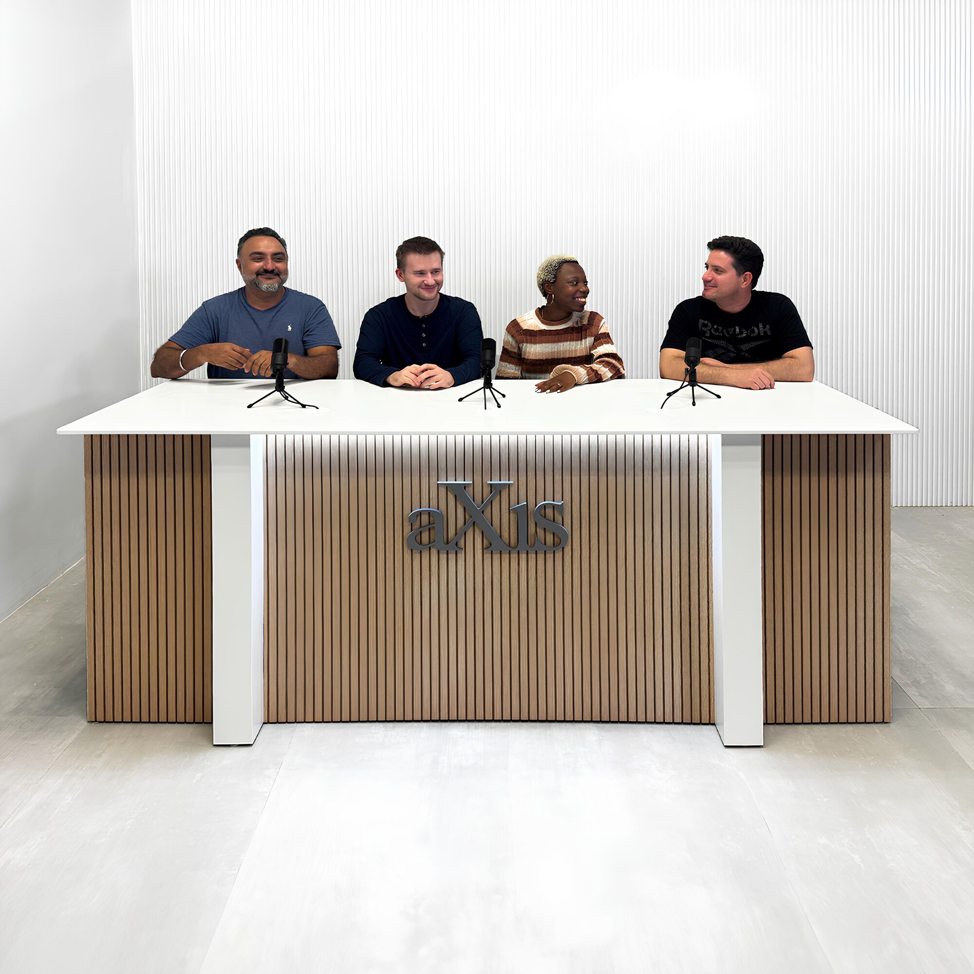 90-inch Savannah Handmade Podcast Table with white solid engineered surface top, white oak tambour front accent, dover off-white matte laminate base and back, and white LED.