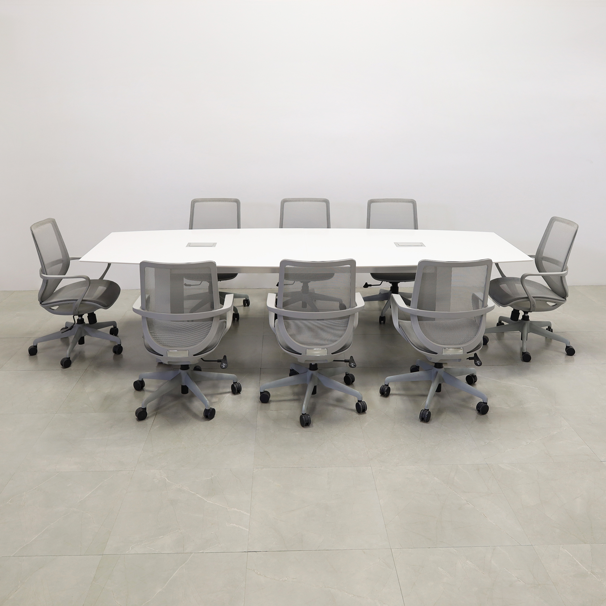 119 inches Aurora Boat Shaped Conference Table with White Solid Engineered Stone Top and Brushed Aluminum finish base, two Ellora power boxes, and eight gray chairs shown here.