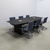 114 inches Aurora Boat Shape Conference Table with Black Traceless Engineered Stone top with two Ellora power boxes and black matte laminate base, and six blue chairs shown here.