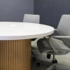 48-inch Newton Round Conference Table in white gloss laminate top and white oak tambour base, with white MX1 powerbox, shown here.