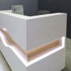72 inches Wave Reception Desk in white matte laminate desk and counter, white oak wave accent front and brushed aluminum toe-kick, with warm white LED shown here.
