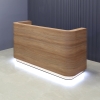 84 inches Nola Reception Desk in uptown walnut laminate desk and brushed gold aluminum toe-kick, with warm white LED shown here.