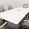 Omaha Rectangular Conference Table With Tempered Glass Top in white top and white gloss laminate base, with one ellora power box shown here.