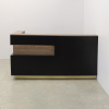 84-inch Manhattan L-Shape Custom Reception Desk in walnut heights matte laminate accent panel and top counter, and black traceless laminate main desk. Gold aluminum toe-kick, with multi-colored LED, shown here.