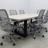 92 inches Newton Boat Shaped Conference Table in Beige Traceless Laminate Top with one Ellora power box and Black Traceless open legs, and six gray chairs shown here. 