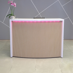 Seattle X1 Custom Reception Desk in white gloss laminate desk and maple tambour on curved front panel, with multi-colored LED shown here.